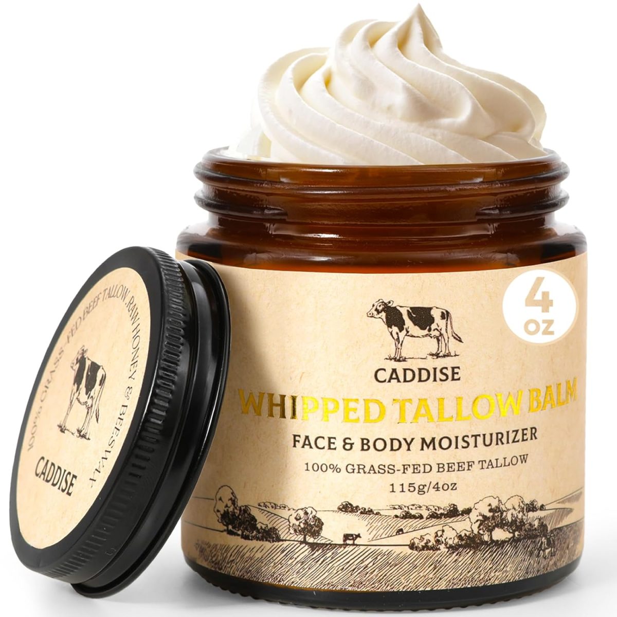 An open jar of Caddis Whipped Tallow Balm face and body moisturizer, perfect for Black Friday skincare hauls, with a swirl of cream inside and a lid beside it. The label highlights its 100% grass-fed beef tallow ingredients.