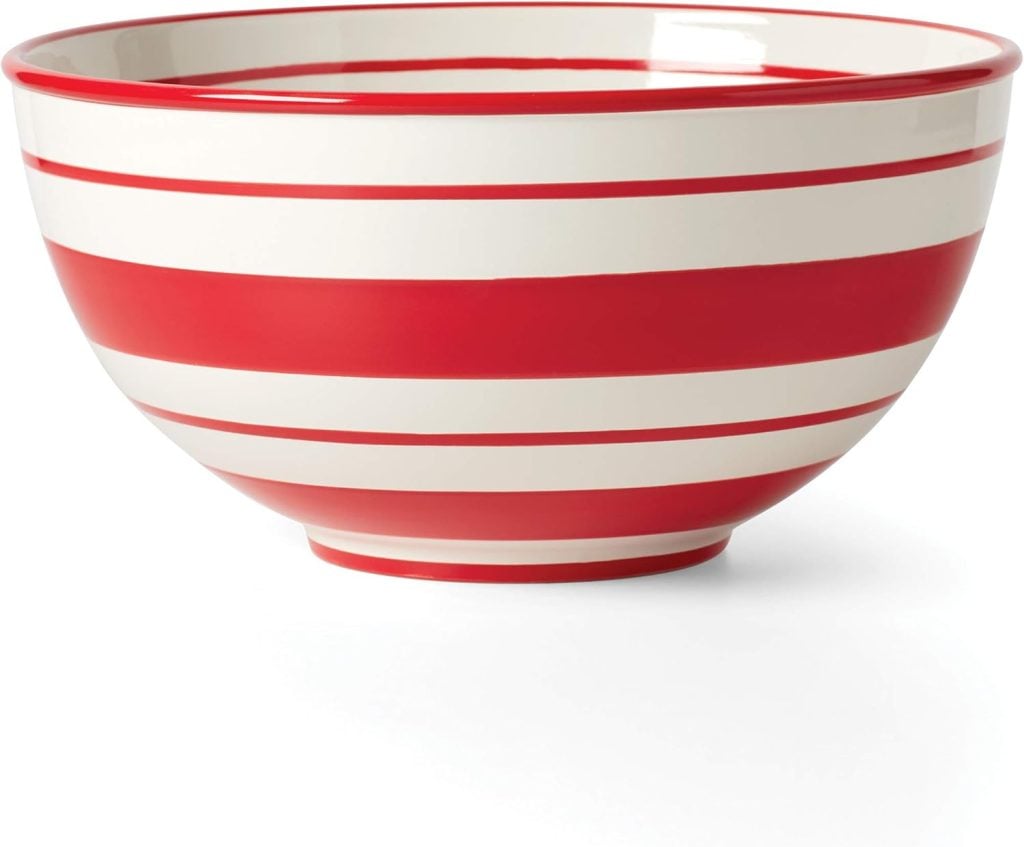 A red and white striped ceramic bowl, perfect for holiday desserts, features a wide opening and a small base.