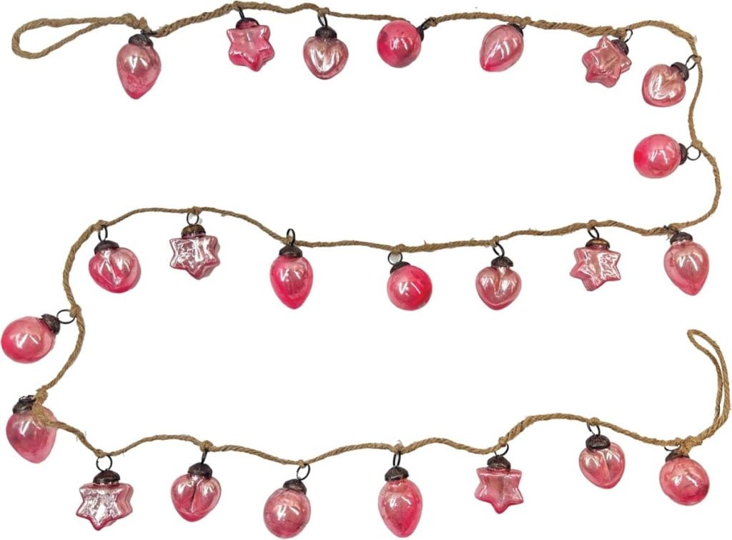 A string of twine with pink Christmas glass ornaments shaped like stars, hearts, and spheres evenly spaced along its length.