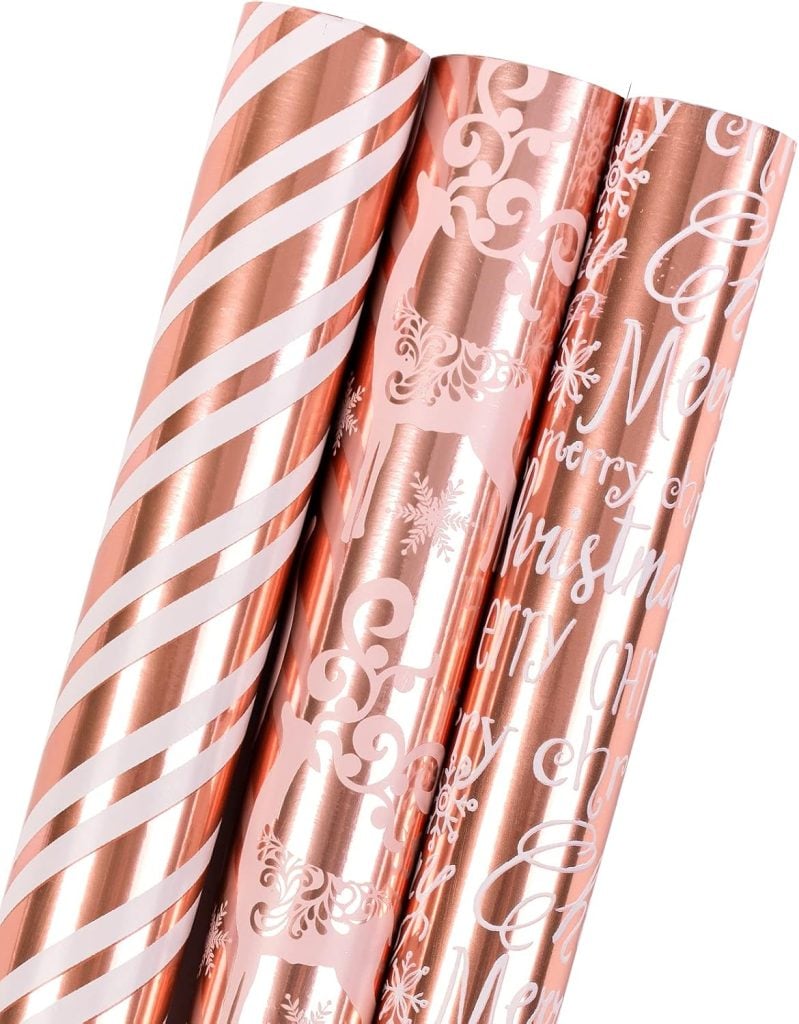 Three rolls of rose gold wrapping paper, featuring striped, reindeer, and Christmas text designs—perfect for any gift. Enhance your presents by learning how to tie a bow that complements these festive patterns.