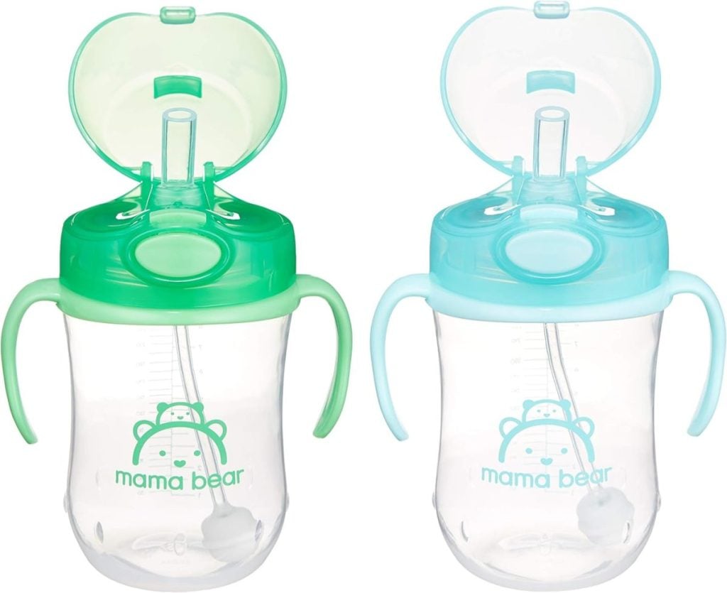 Two transparent sippy cups with soft straws and handles, one with a festive green lid and the other with a cheery blue lid, featuring a "mama bear" logo. Perfect for little ones during Nutcracker Christmas celebrations.