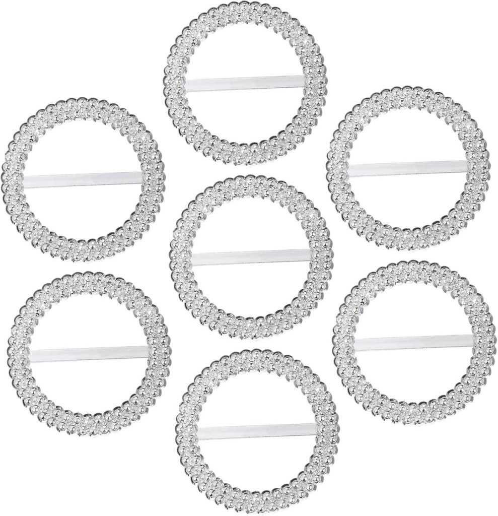 Seven clear, coiled hair ties arranged in a circle pattern on a white background evoke the elegance of Christmas ribbon with their smooth, glossy loops.