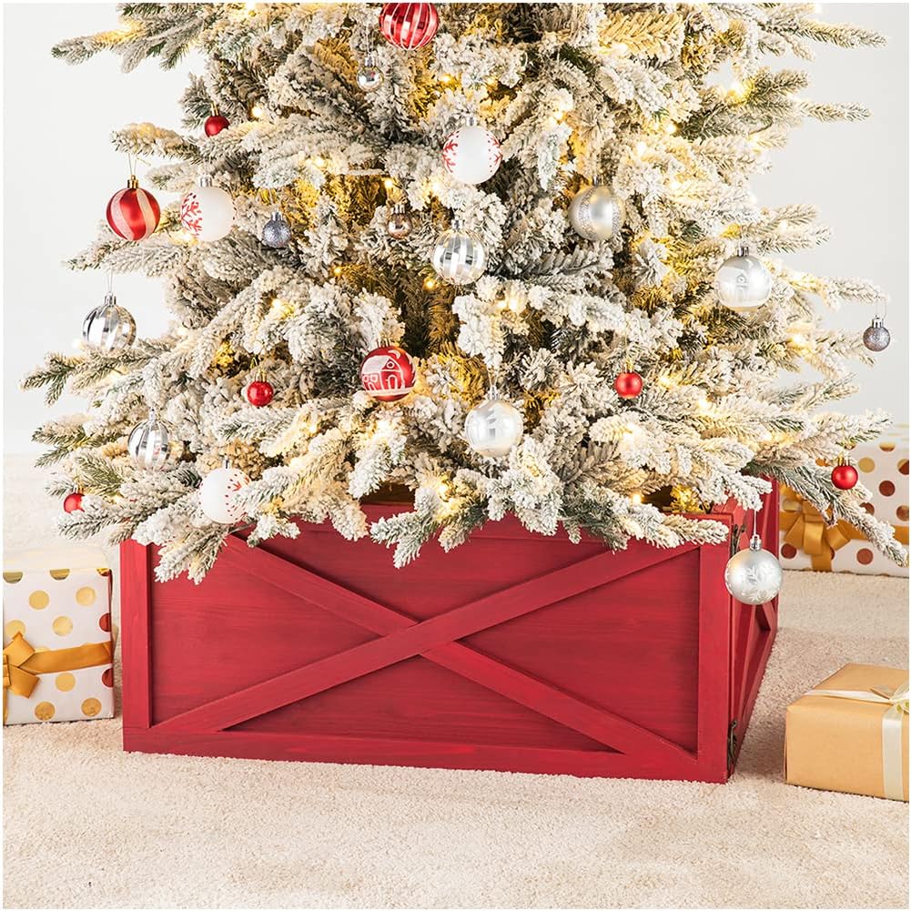 An artificial Christmas tree in a red wooden stand, adorned with red and silver ornaments, rests gracefully atop a festive Christmas tree skirt. Wrapped gifts are nestled nearby, completing the cozy holiday scene.