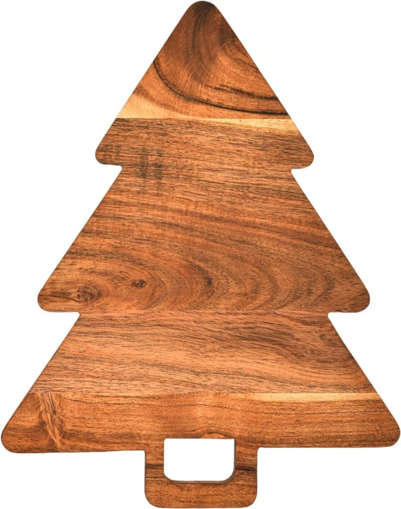 A wooden cutting board shaped like a Christmas tree, perfect for serving festive treats like Christmas tree cupcakes.