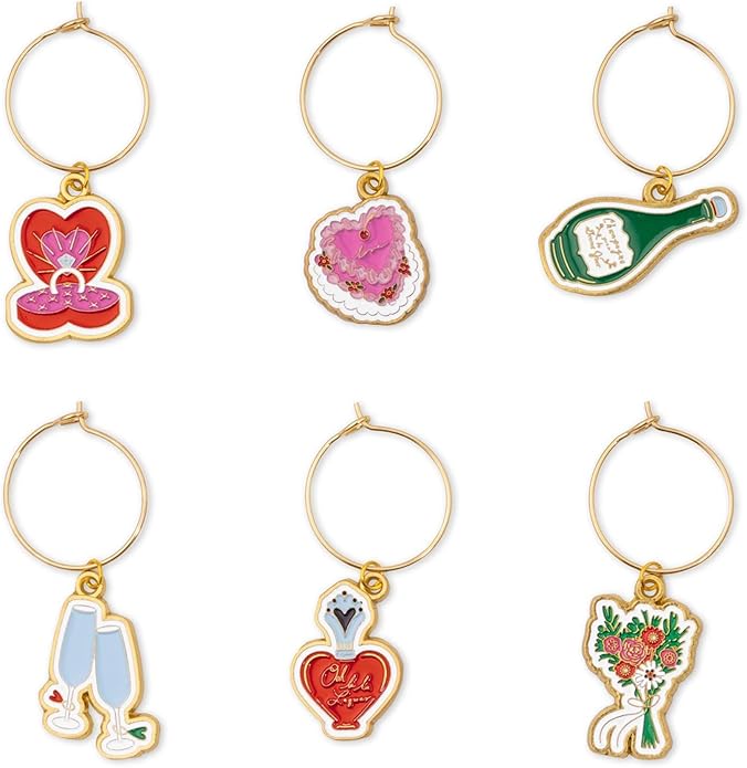 Six wine glass charms featuring designs of a ring box, heart-shaped cake, champagne bottle, glasses, heart lock, and bouquet.