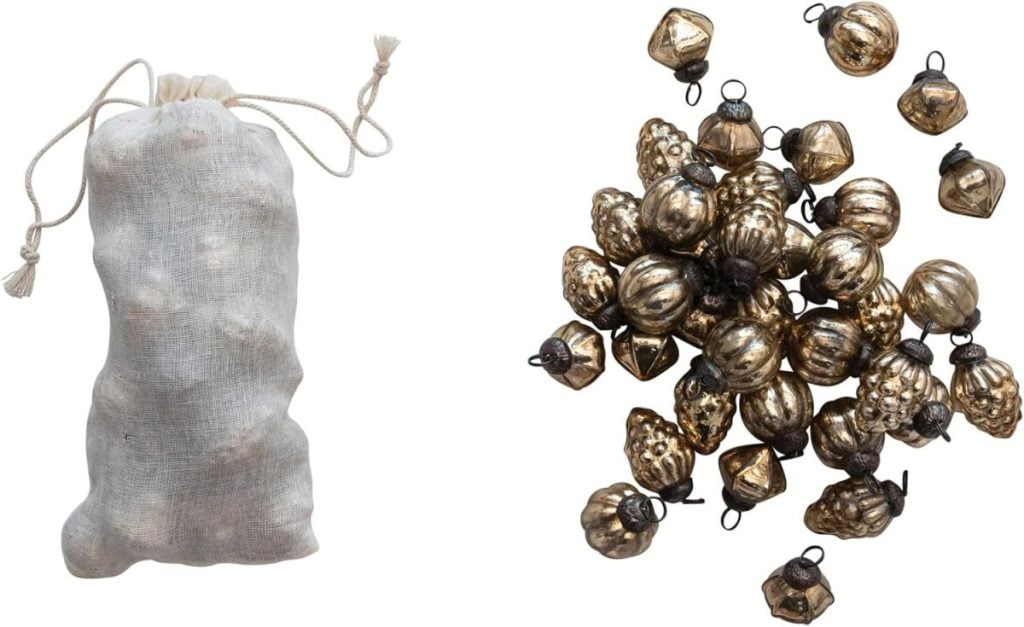 A drawstring pouch on the left and a scattered pile of small, metallic, decorative oyster shell ornaments on the right.