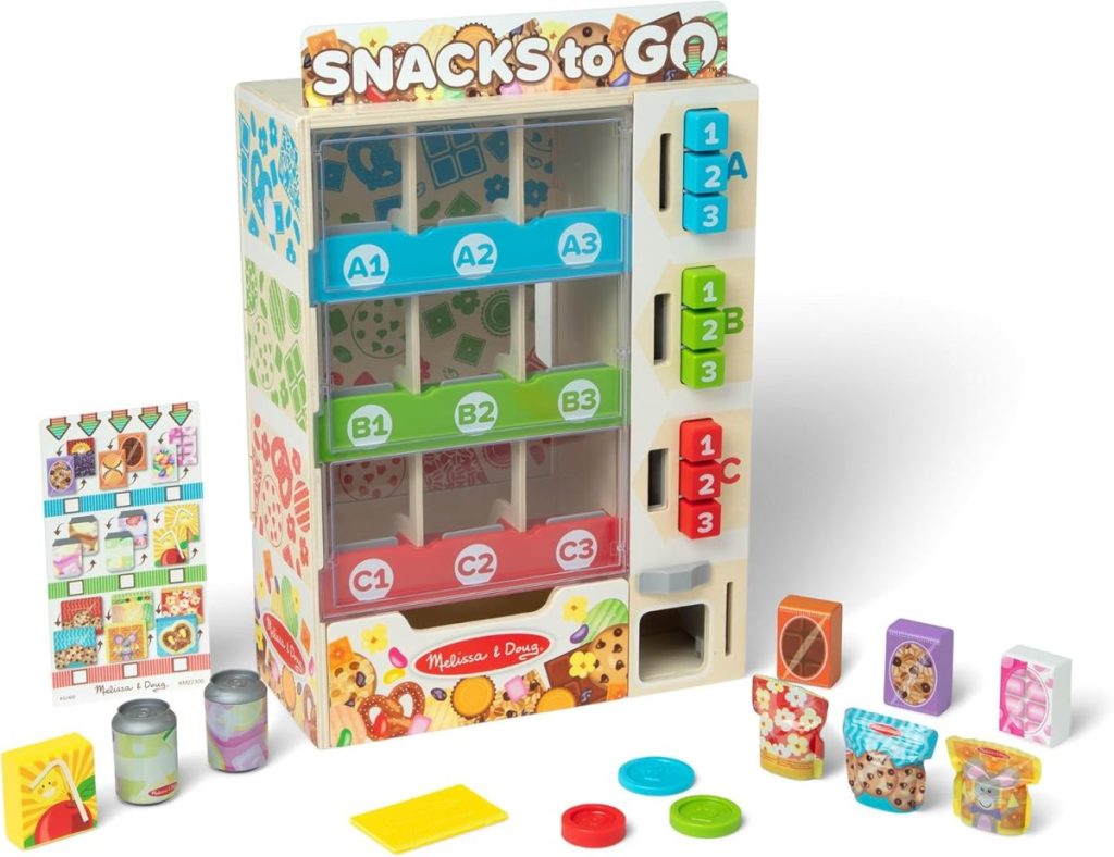 A colorful toy vending machine labeled "Snacks to Go" with compartments, play snacks, pretend coins, and a menu card—perfect for Black Friday gift shopping!.
