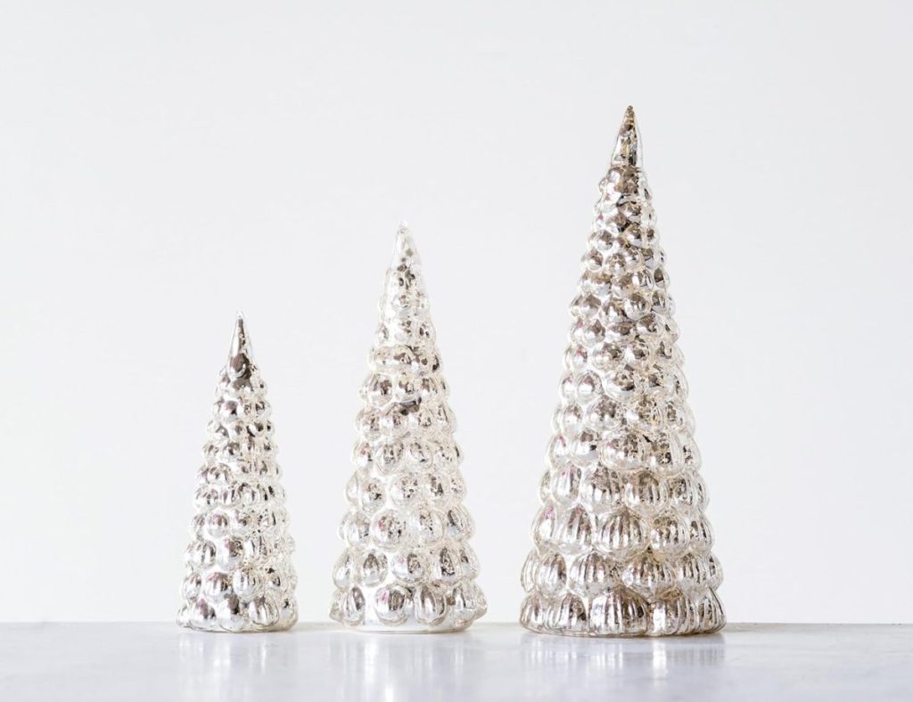 Three silver decorative glass trees of varying heights are displayed on a flat surface against a plain white background, making them the perfect centerpiece to set a Christmas table with festive elegance.