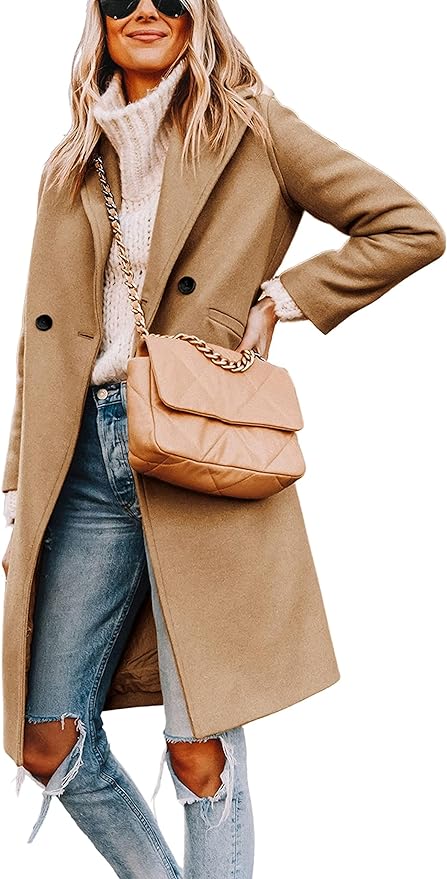 A person in a camel coat, white sweater, and ripped jeans holds a tan quilted purse, exuding a festive charm reminiscent of a Nutcracker Christmas.