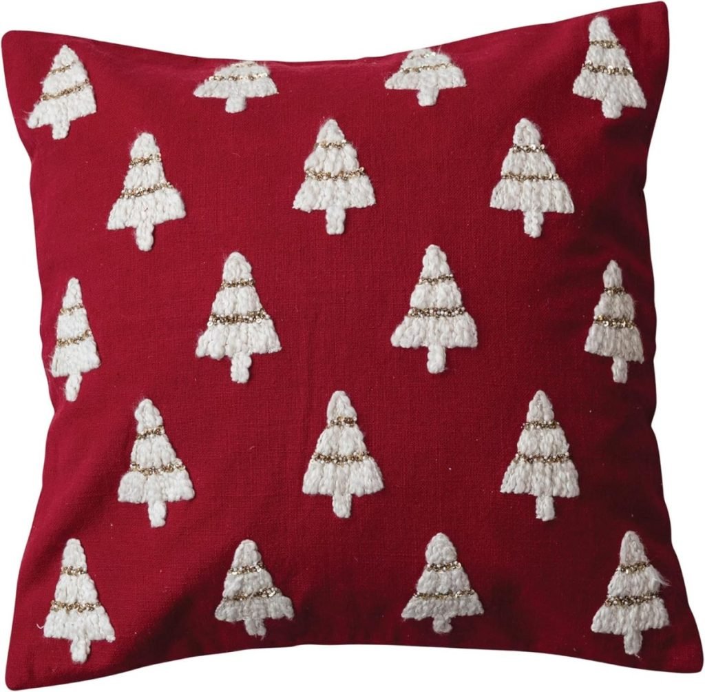 A cozy red pillow adorned with white and gold embroidered Christmas trees arranged in rows, perfectly capturing the essence of classic Christmas colors.