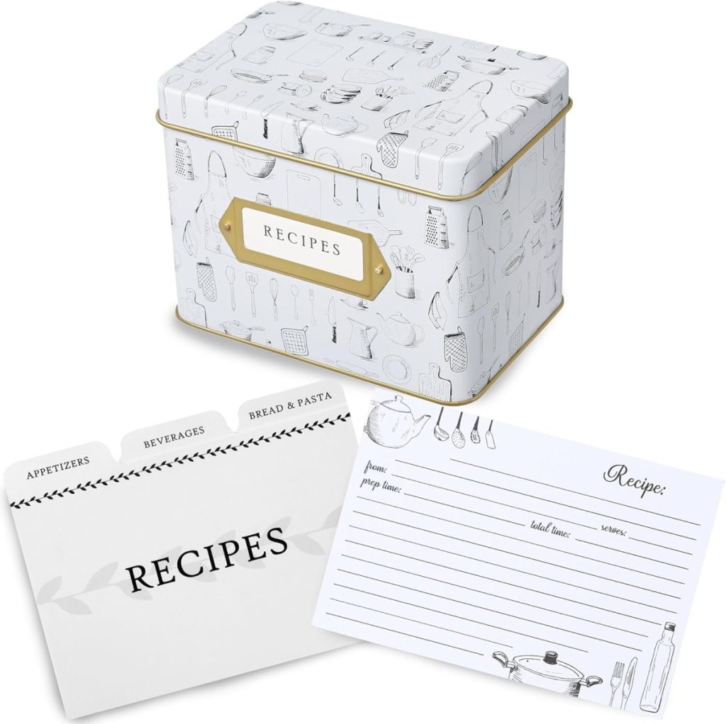 A decorative recipe tin with kitchen utensil illustrations, a gold "RECIPES" label, and recipe cards with dividers—perfect for organizing appetizers, beverages, and bread & pasta recipes during the holiday season.