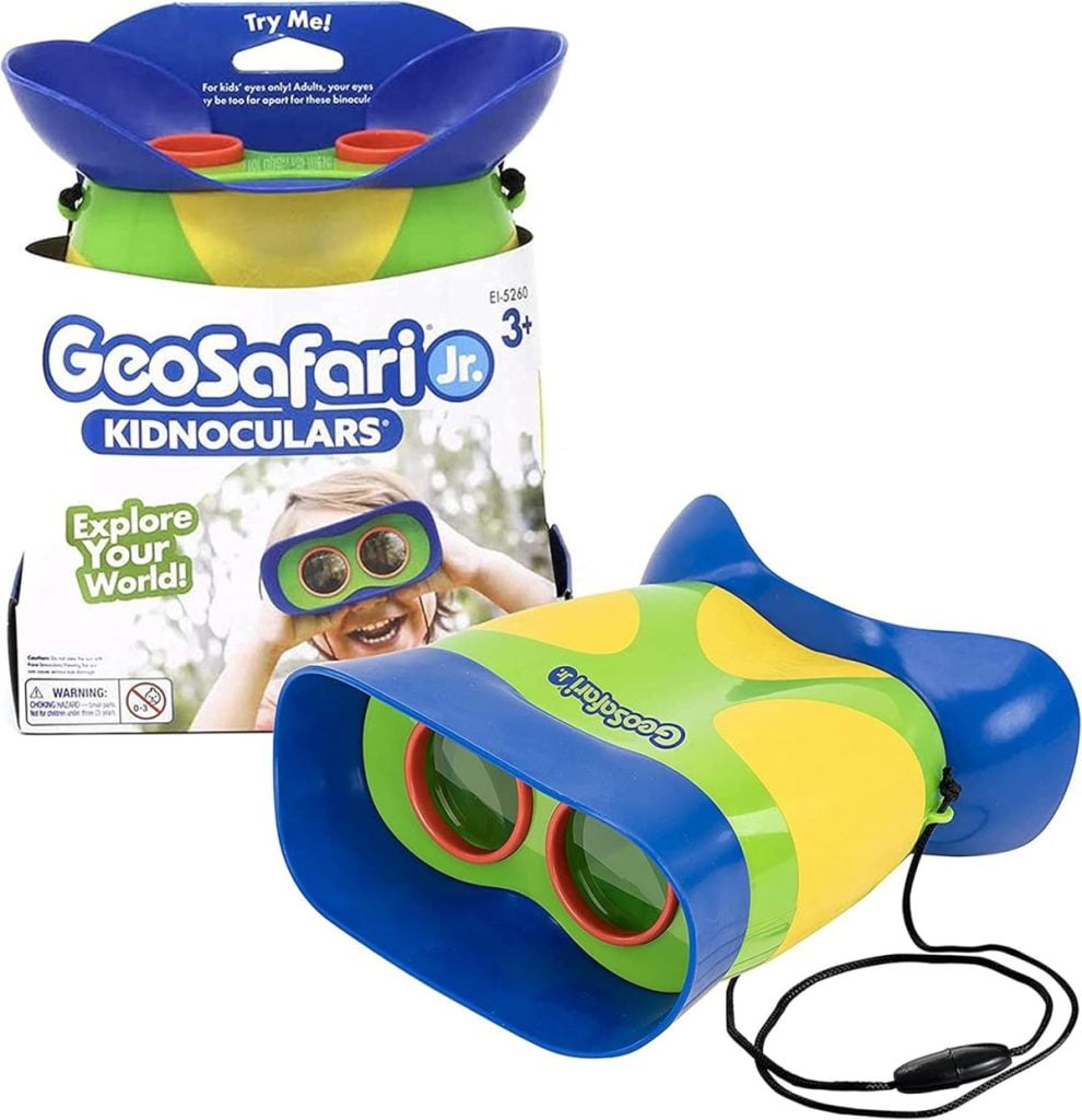 Colorful GeoSafari Jr. Kidnoculars toy binoculars with green and yellow body, blue eyepieces, and neck strap—perfect for Christmas morning excitement for children ages 3 and up. Comes with packaging.