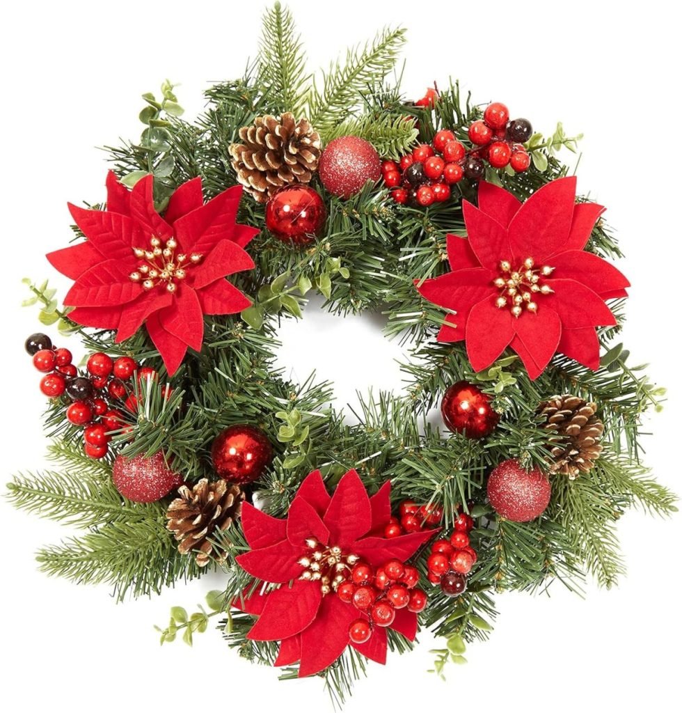 A festive Christmas wreath adorned with red poinsettias, pine cones, red berries, and lush green foliage.