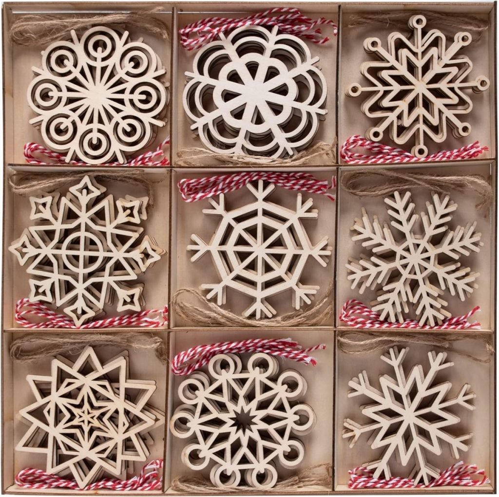 Nine intricately carved wooden snowflake ornaments are displayed in a grid-lined box, each adorned with red and white twine for hanging. Learn how to tie a bow perfectly to add an extra touch of elegance to these festive decorations.