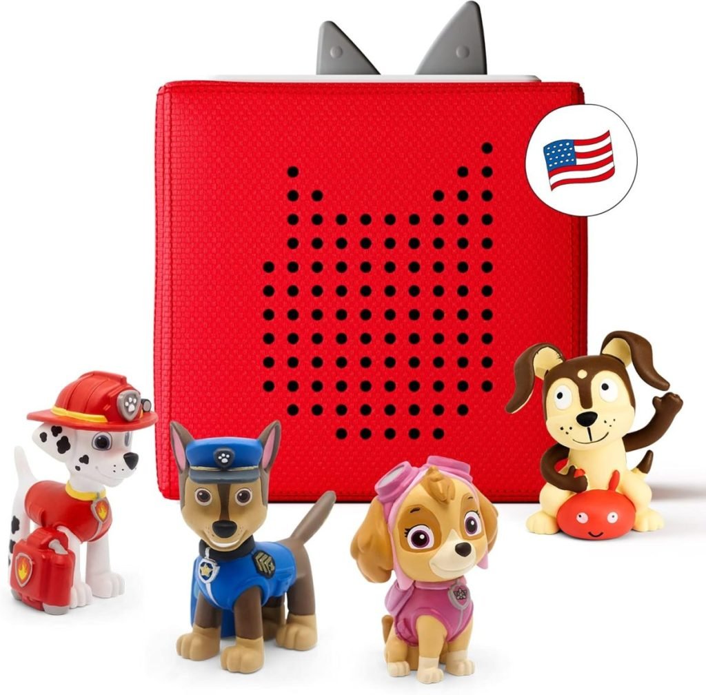 Red speaker box with ears, adorned with cartoon dog figures. Perfect for Black Friday finds, it features three dog toys in firefighter, police, and aviator outfits, plus a brown dog with a red ball. A U.S. flag icon is clearly visible.