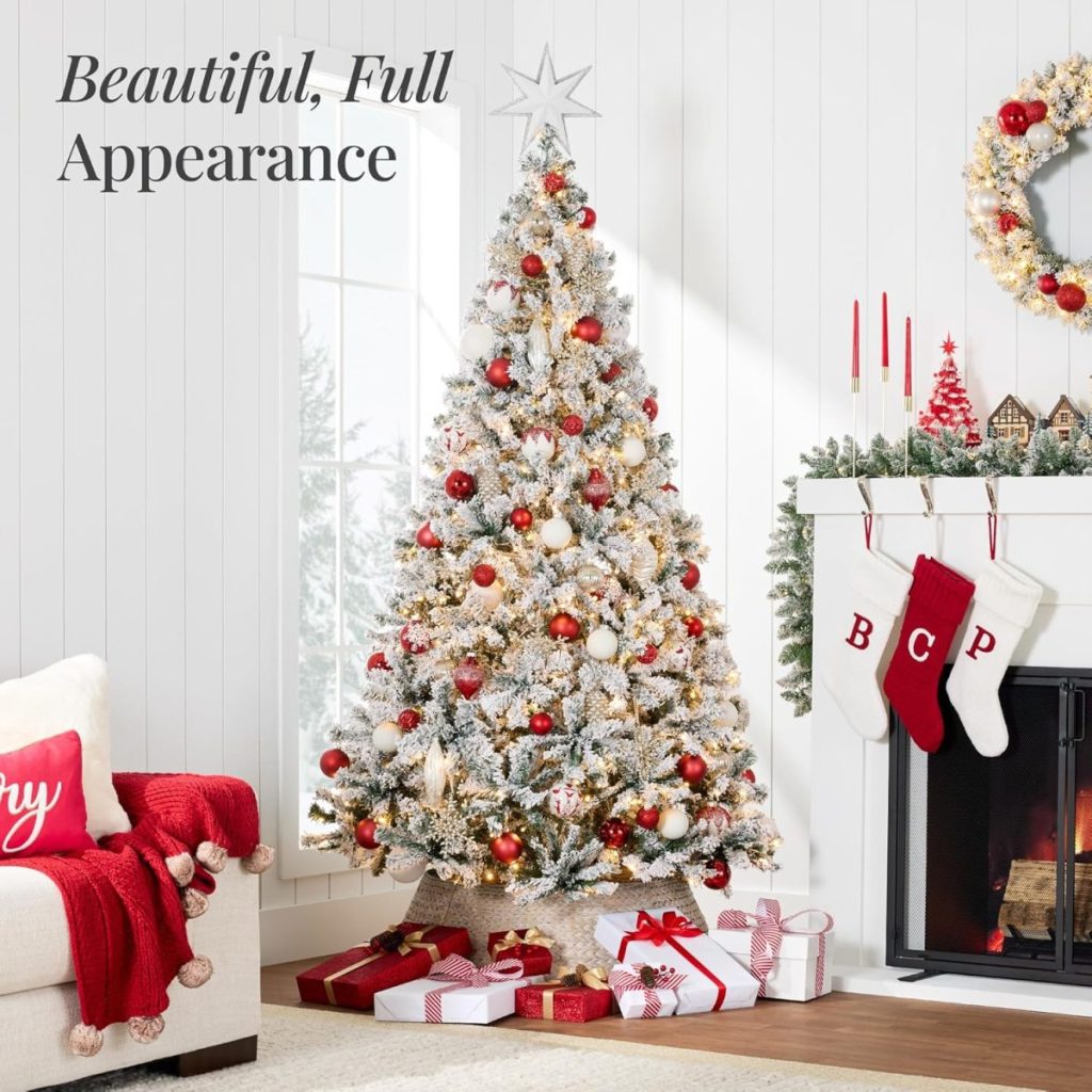 A flocked Christmas tree decorated with red and gold ornaments stands by a fireplace with stockings and wrapped presents underneath, ready to make your Black Friday extra special. The room is adorned in festive red, white, and gold.