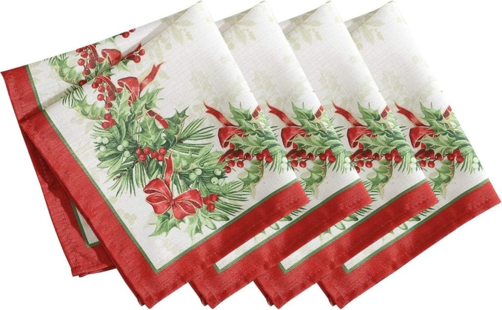 Four holiday-themed napkins with red borders and festive designs of berry, pine, and ribbon add charm to your table. Perfect for Black Friday gatherings or any seasonal celebration.