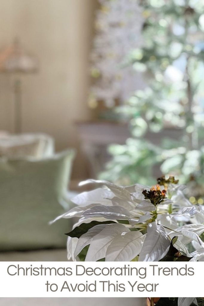 A white poinsettia in focus with blurred backgrounds of soft greens and creams, featuring text: "Christmas Decorating Trends to Avoid This Year.