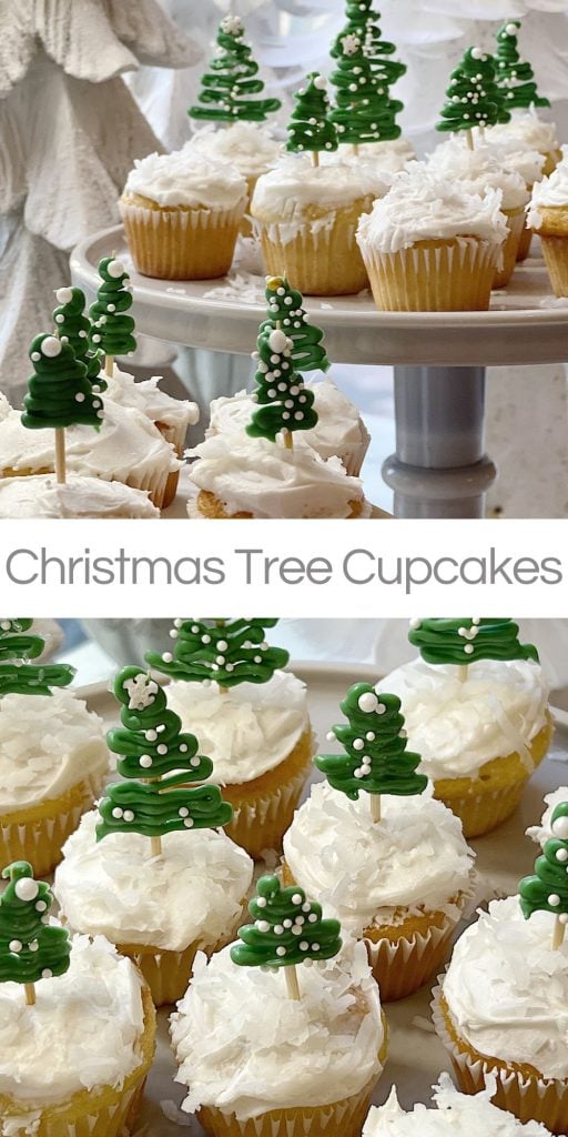 Cupcakes topped with green Christmas tree decorations and white icing are displayed on a two-tier stand.