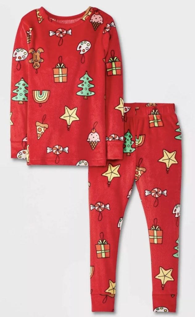 Red pajamas with holiday-themed prints, including trees, stars, gifts, candy, and ornaments.