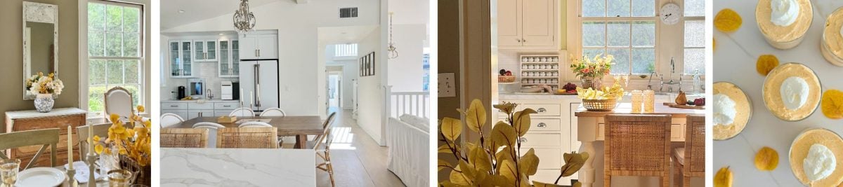 A bright, airy kitchen with white cabinets, wooden dining table, and wicker chairs. Sunlight streams in through large windows, highlighting yellow flowers on the table and counter.