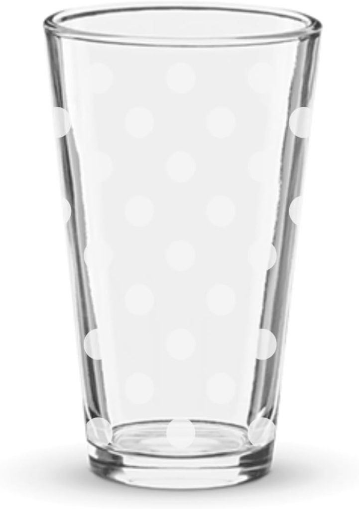 A clear glass adorned with festive white polka dots captures the essence of Christmas joy in its simple design.