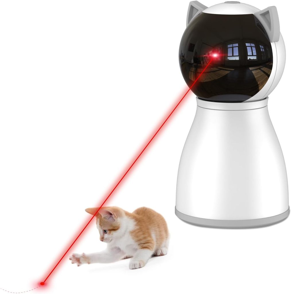 A white automated laser toy projects a red laser dot for a cat to chase—a perfect gift for the season of giving. The cat is focused on the dot and appears ready to pounce.