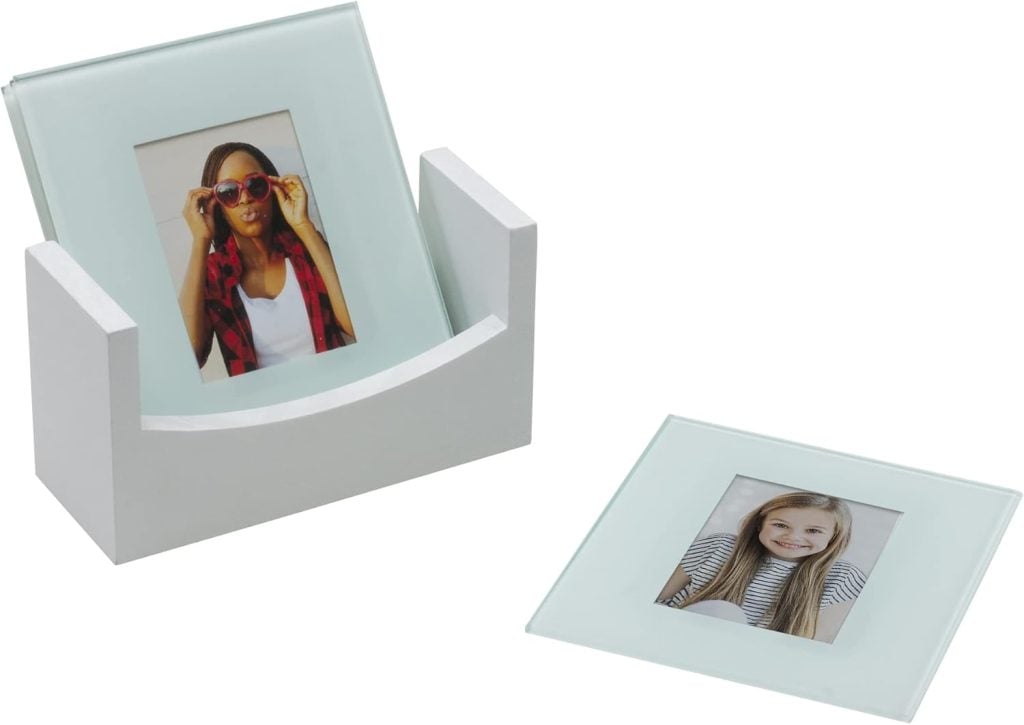 Two photo glass coasters beautifully display a woman in sunglasses and a smiling girl. One coaster is in a holder, while the other lies flat. Perfect for resting your drinks or creatively displaying Christmas cards alongside them during the festive season.