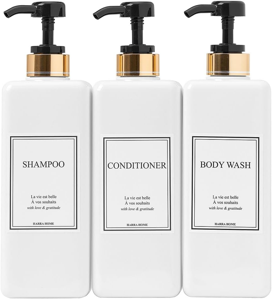 Three white pump bottles labeled shampoo, conditioner, and body wash are arranged side by side.