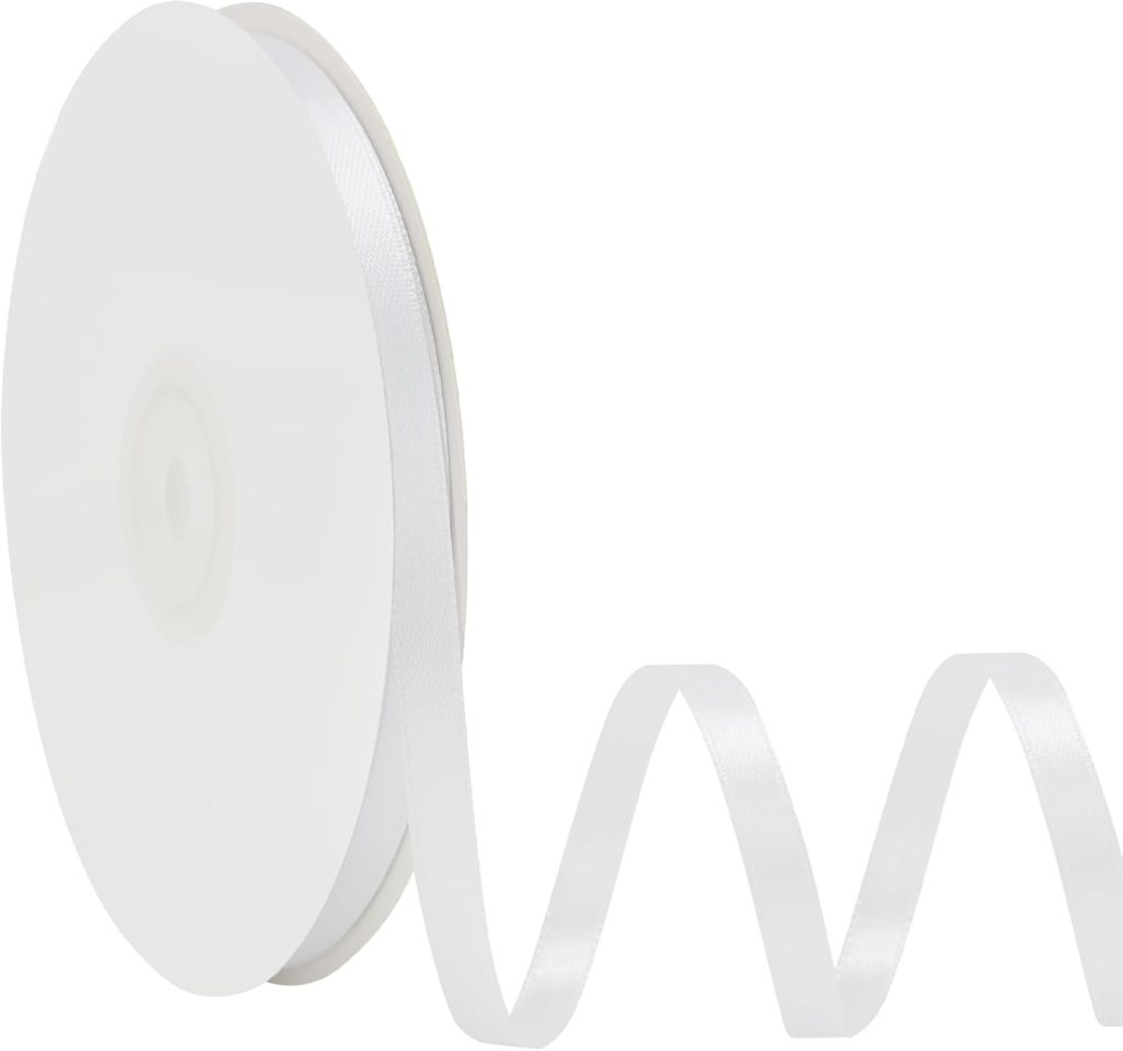 A spool of white ribbon, embodying the spirit of Christmas joy, with a portion unfurled in a wavy pattern.