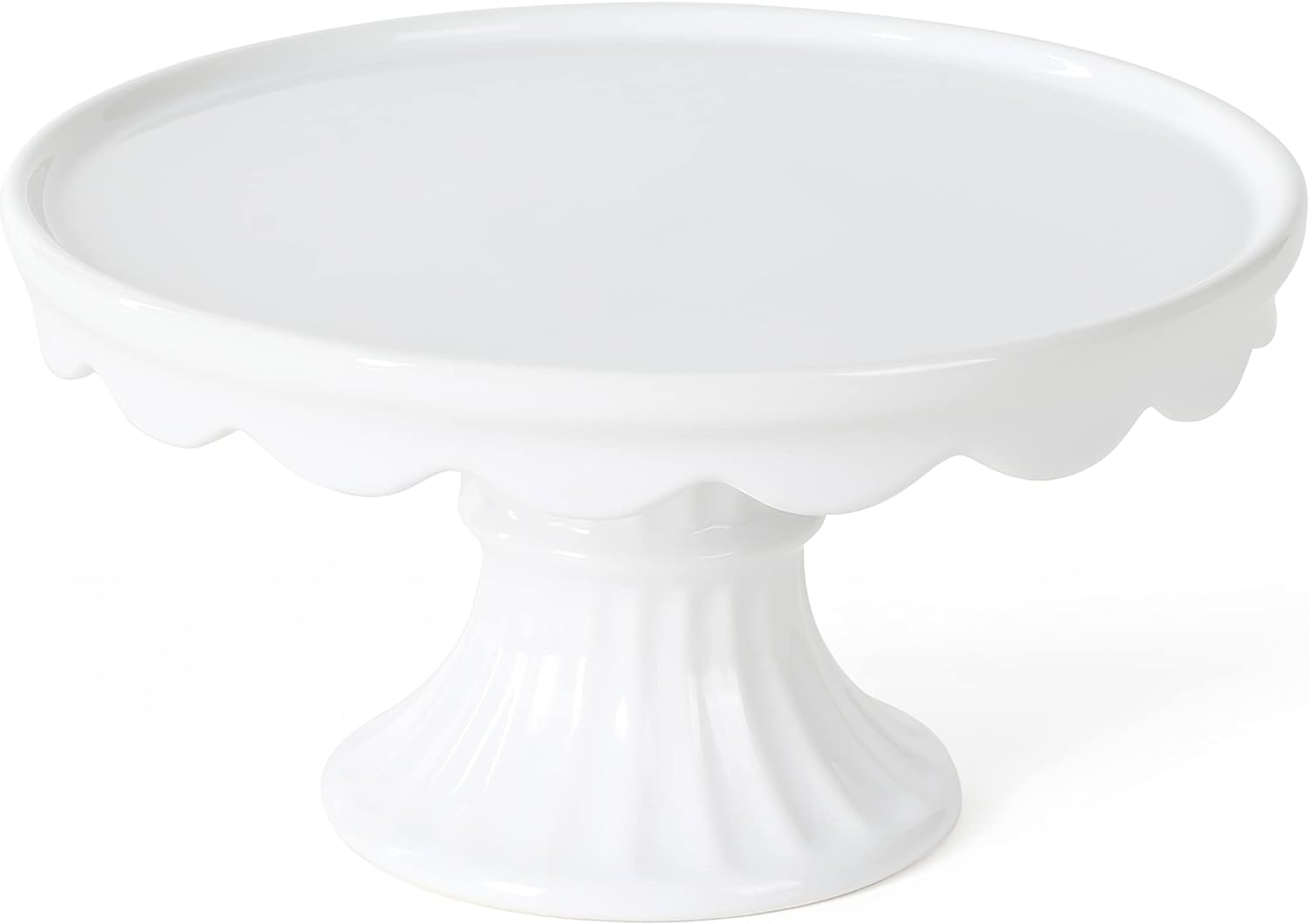 A white ceramic cake stand with a scalloped edge and a fluted base, perfect for displaying treats during your Christmas Morning Breakfast.