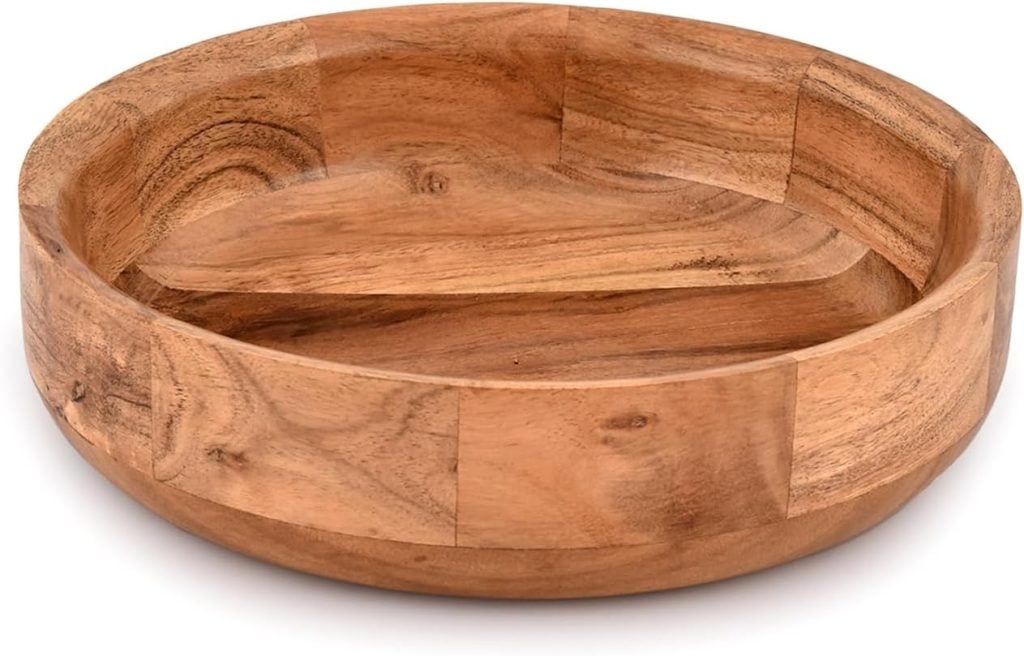 A round wooden bowl with smooth, natural grain patterns on a white background.