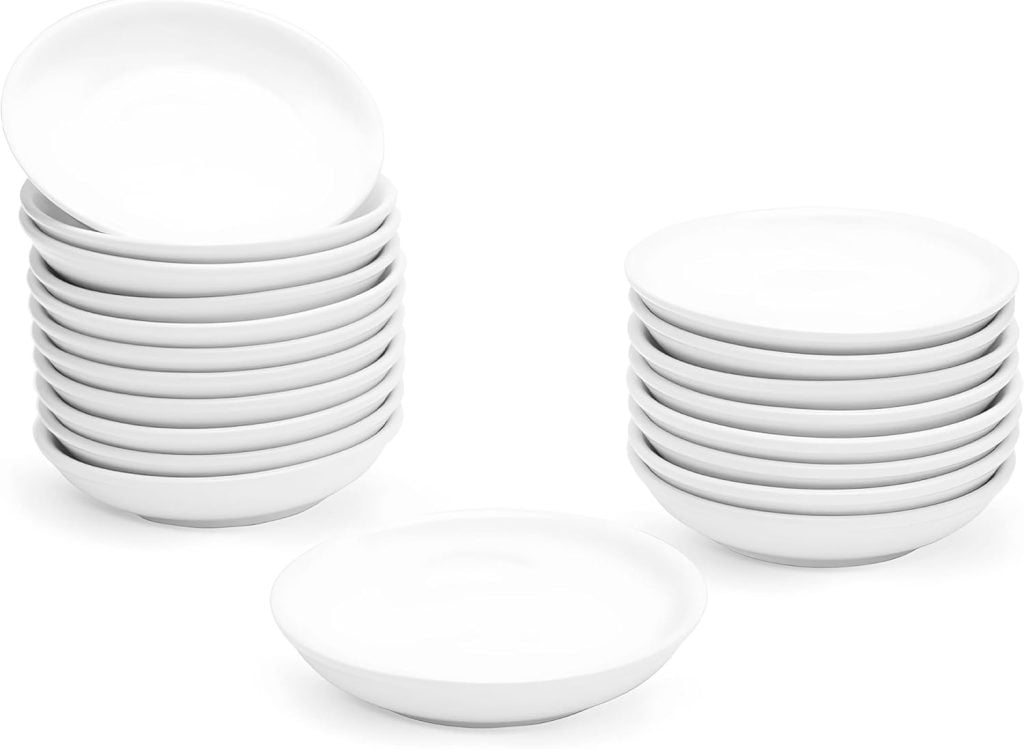 Stacks of white ceramic bowls arranged in rows, with three bowls placed in front, ready to serve delightful dishes at the Christmas party.