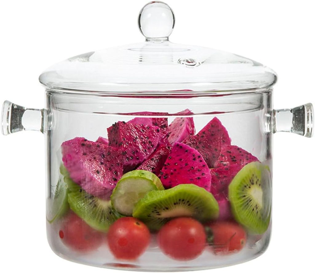 A clear glass pot with a lid, filled with sliced dragon fruit, kiwi, lime, and whole cherry tomatoes—perfect for sharing fresh flavors during the season of giving.