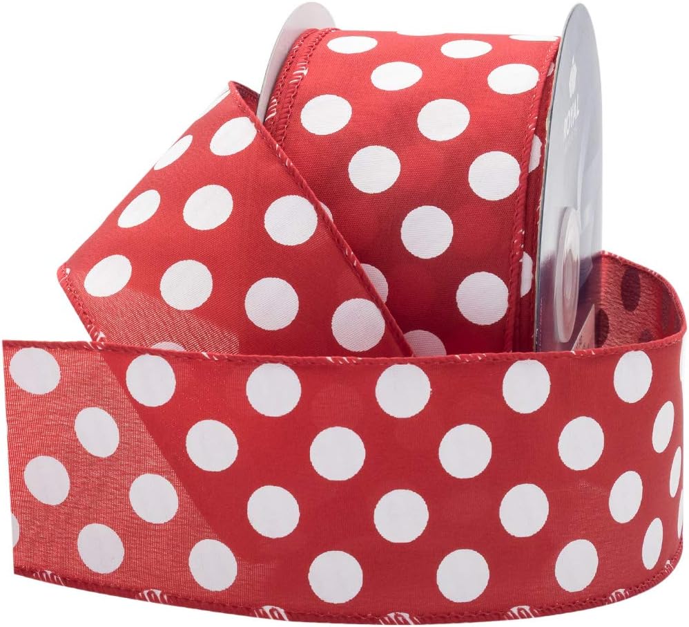 Red ribbon with large white polka dots, partially unspooled from a roll, perfect for adding a touch of Christmas joy.