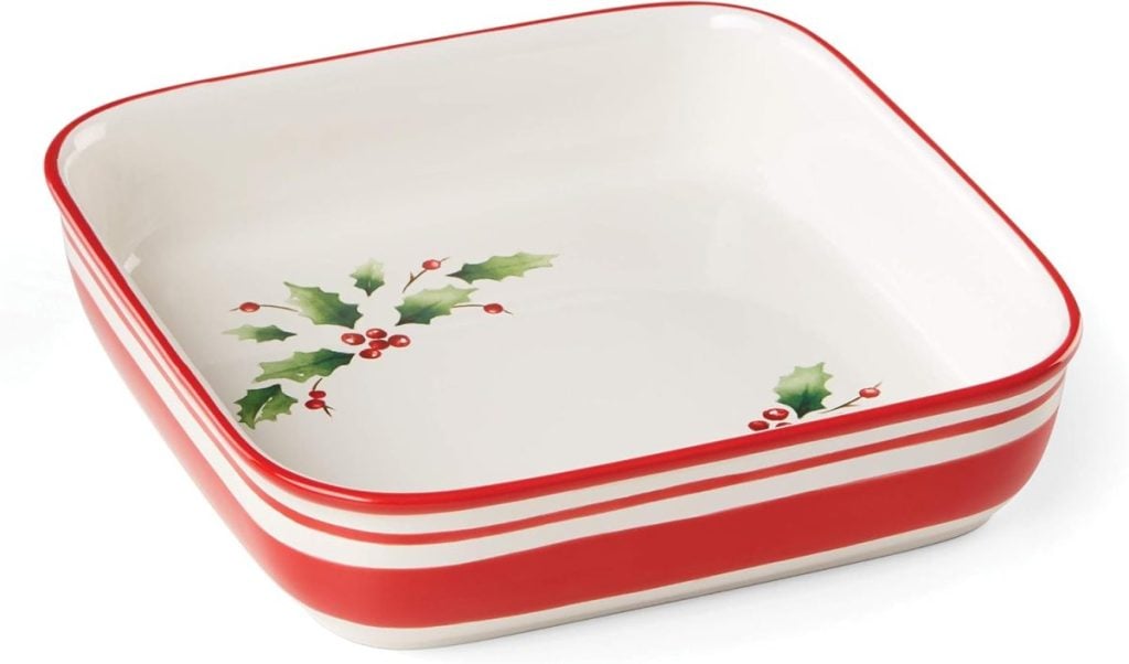 This square dish, perfect for Christmas Eve dinner ideas, features festive red and white stripes on the outside with a charming holly leaf and berry design on the inside.