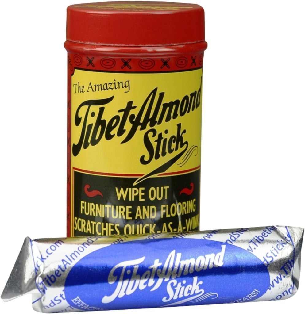 A red and yellow tin labeled "Tibet Almond Stick" sits behind a blue and silver-wrapped stick of the same product, making it a unique addition to creative table setting ideas.