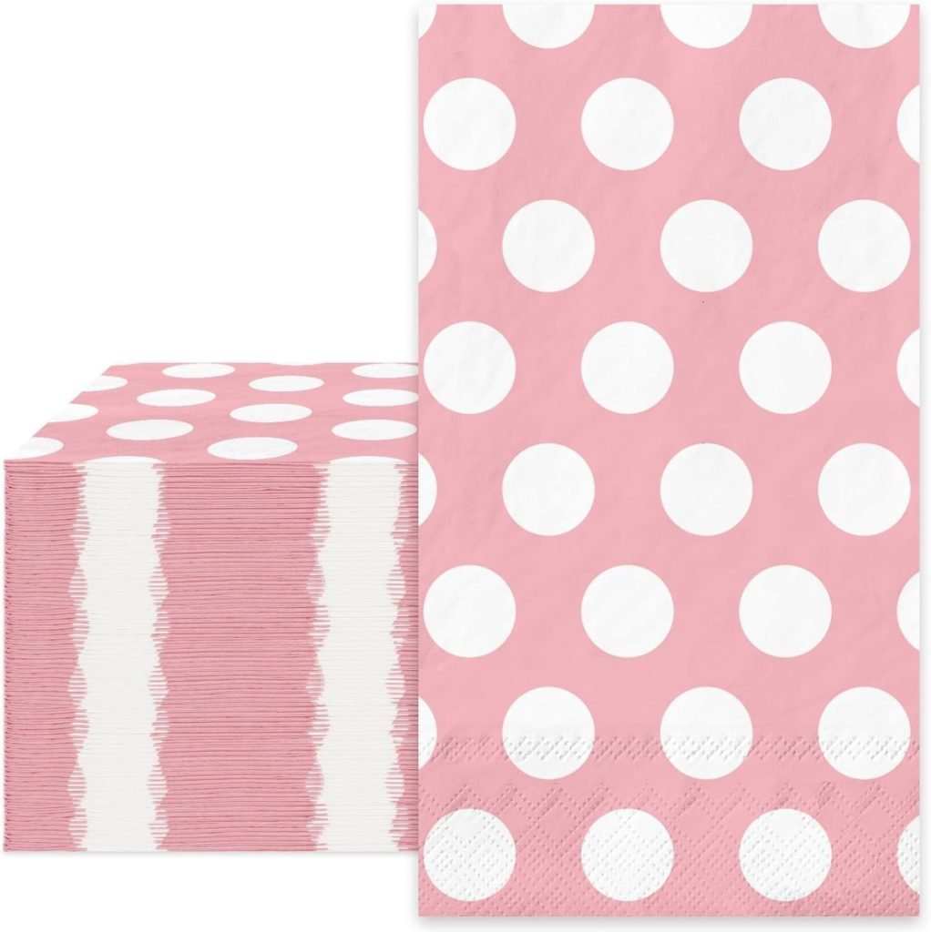 A stack of pink paper napkins with large white polka dots on them.