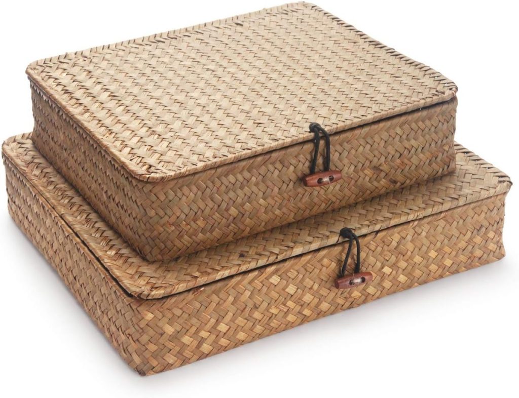 Two rectangular woven wicker storage boxes with lids, stacked on top of each other, each box secured with a string and wooden button closure—perfect for organizing or gifting during the season of giving.