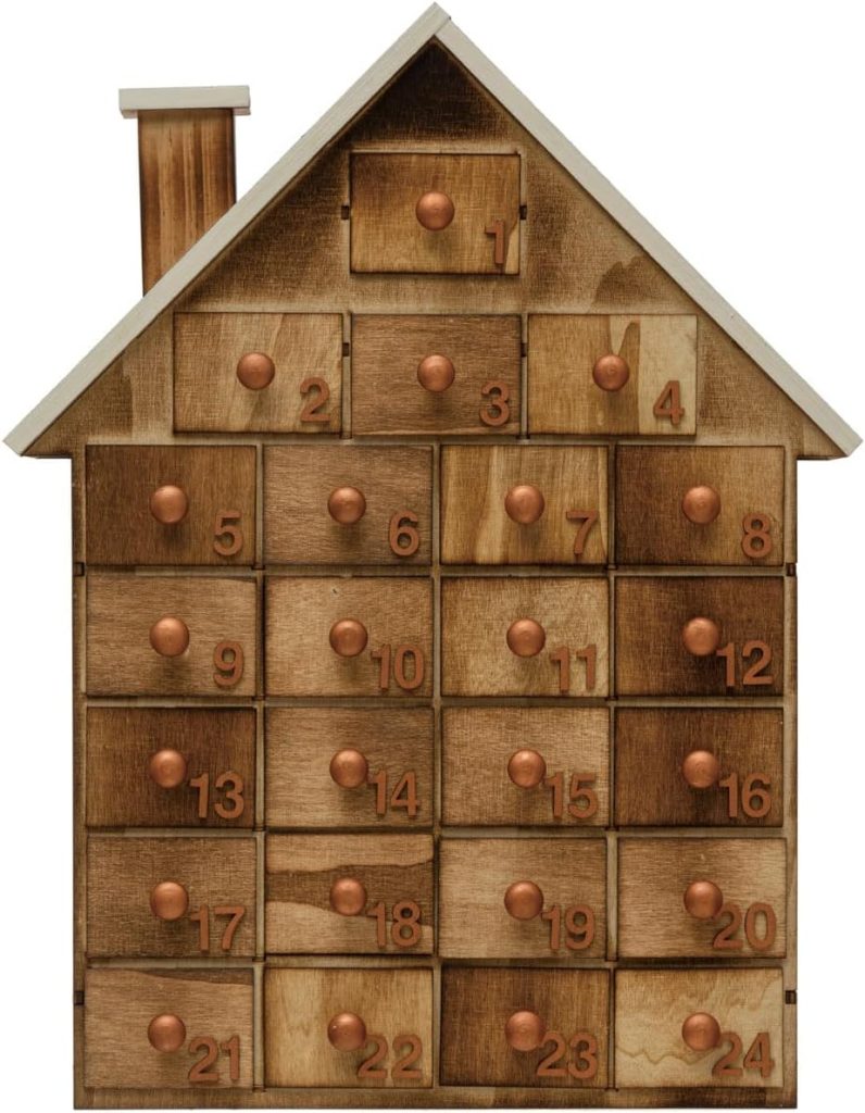 Wooden house-shaped advent calendar with numbered drawers from 1 to 24, each featuring a round knob for opening—perfect to display Christmas cards alongside your festive décor.