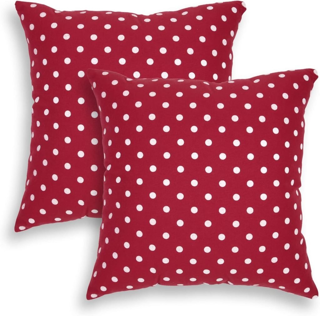 Two red square pillows with white polka dots bring a touch of Christmas joy to your home, adding festive charm and coziness.