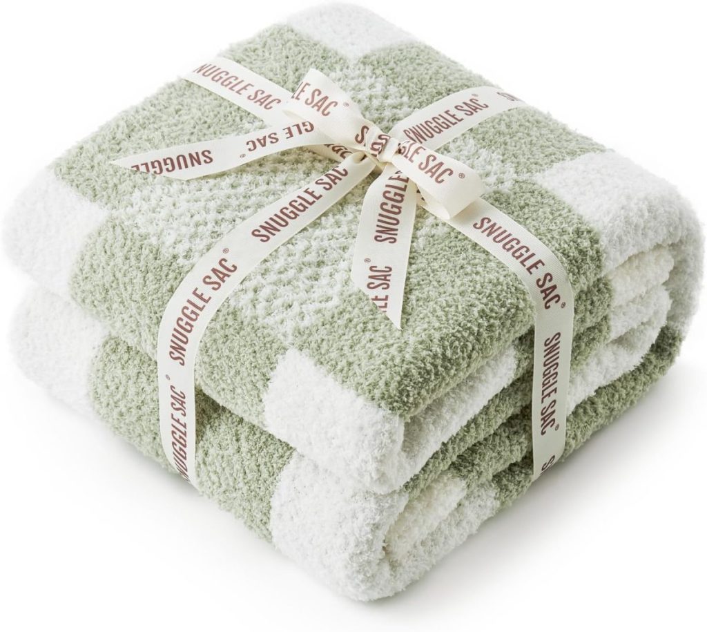 Green and white checkered blanket, folded and tied with a ribbon labeled "Snuggle Sac.