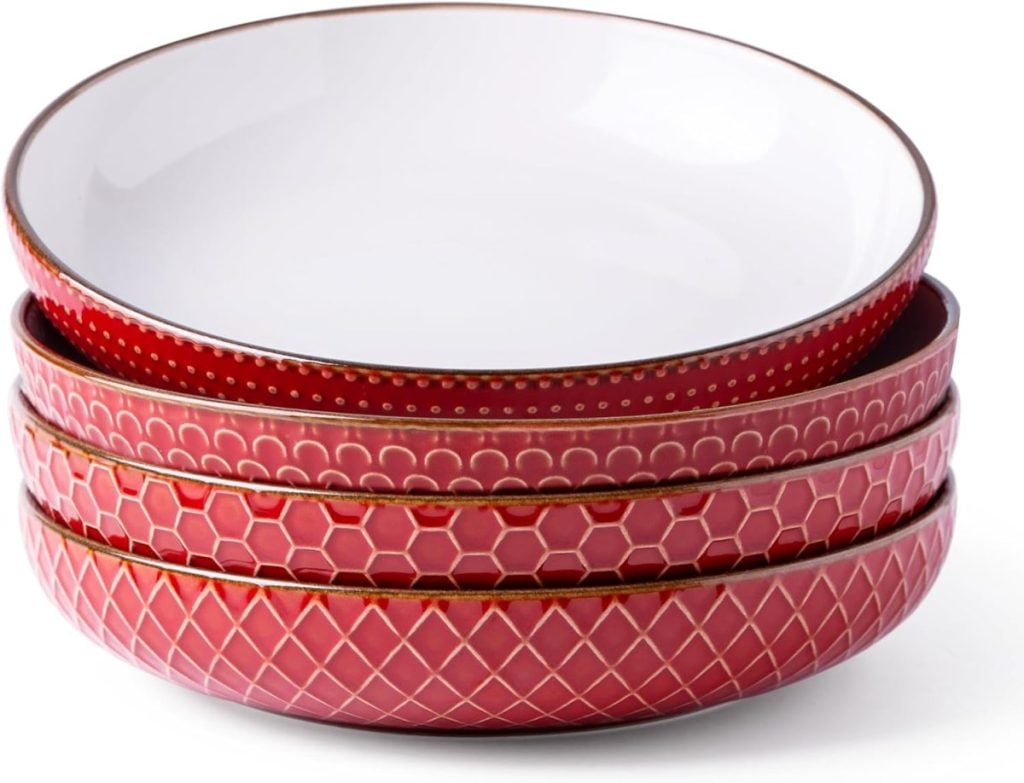 Perfect for Christmas Eve dinner ideas, these four stacked bowls boast red exteriors with various textured patterns and simple white interiors.