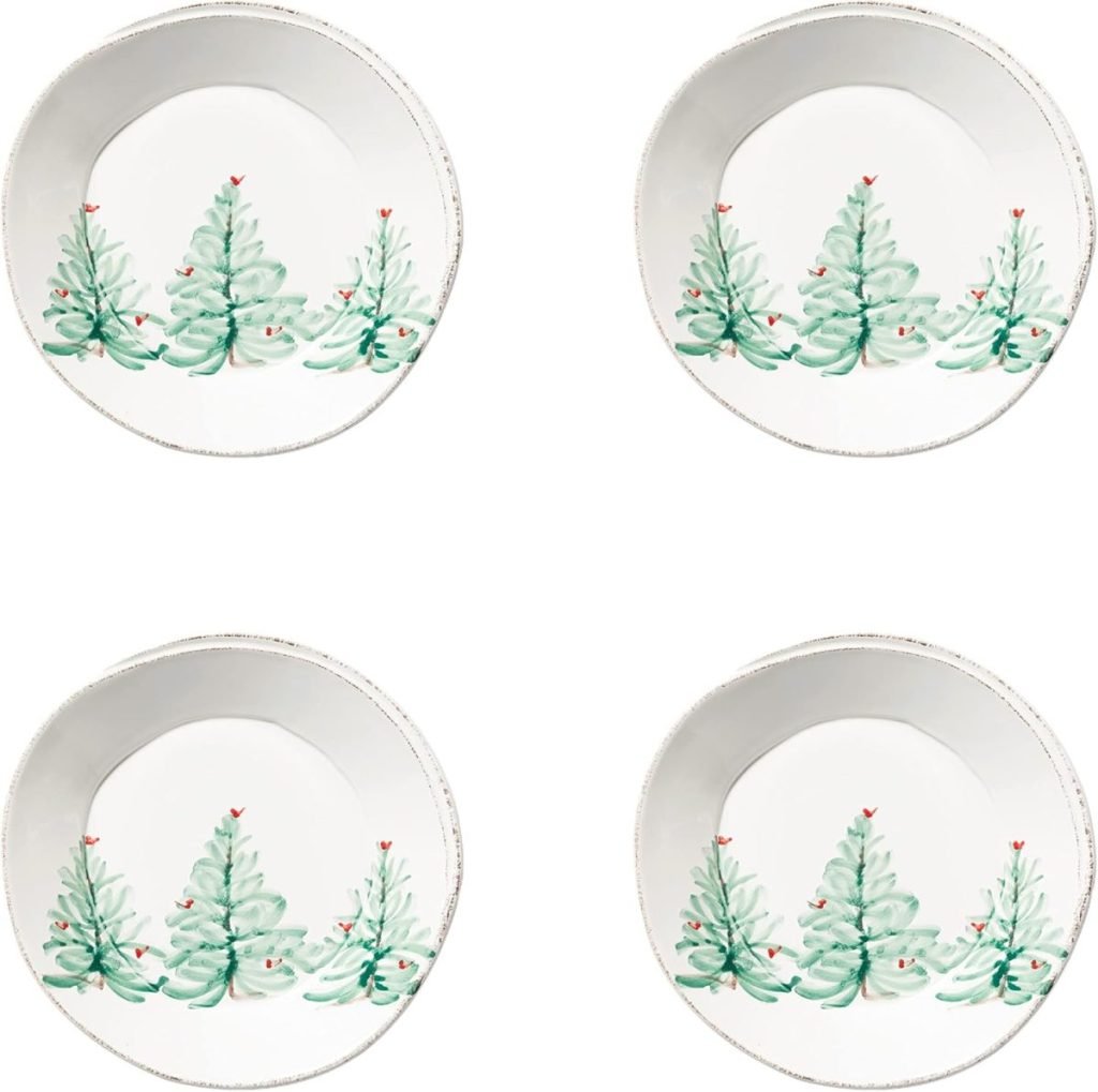 Four white plates with green Christmas tree designs, arranged in a grid pattern, provide inspiration for your Christmas Eve dinner ideas.