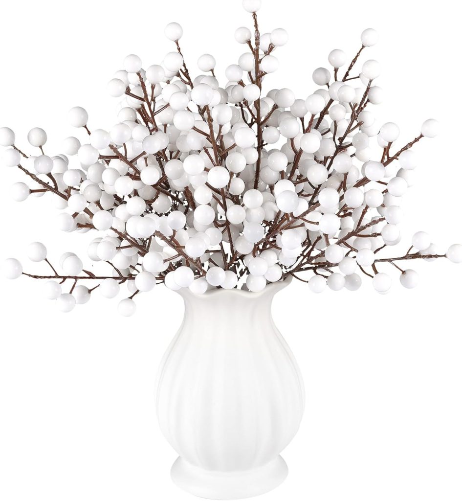 White ceramic vase filled with artificial branches bearing clusters of white, round berries on brown stems, arranged in a full bouquet—perfect to display Christmas cards alongside your festive decor.