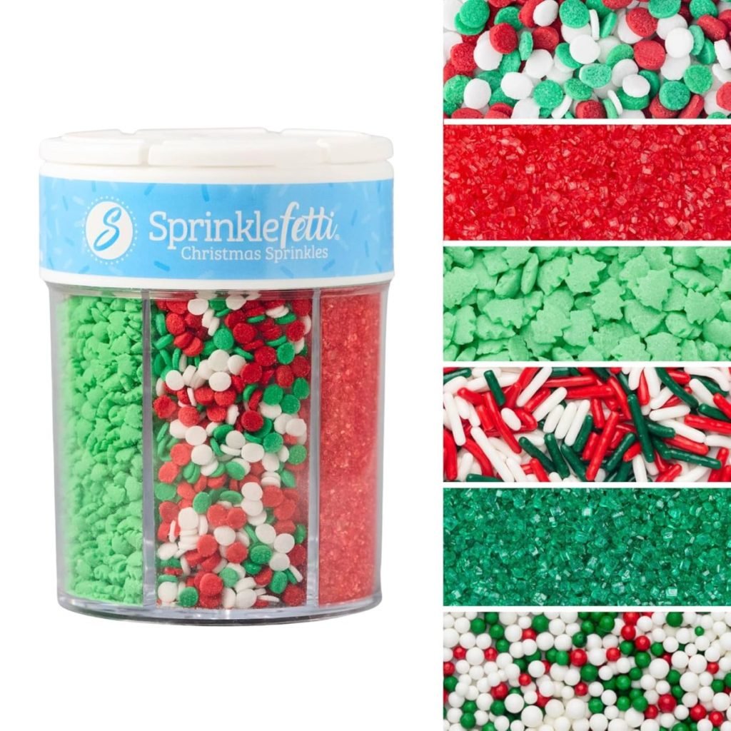 A clear container labeled "Sprinklefetti Christmas Sprinkles" holds festive green, red, and white sprinkles with various shapes and textures.