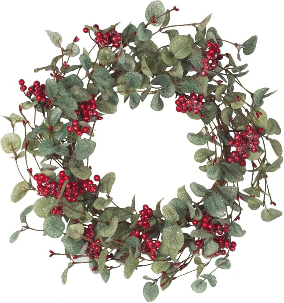 A circular wreath made of green leaves and red berries, arranged in a natural, festive style—perfect as a centerpiece for your Christmas Morning Breakfast.