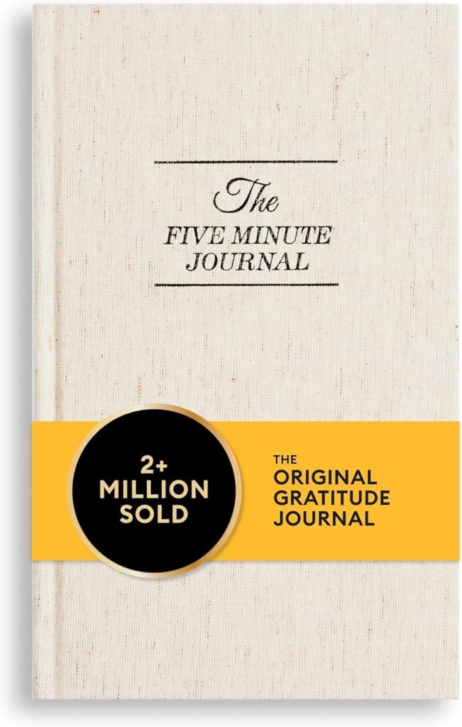 Cover of "The Five Minute Journal" with a beige textured background and a yellow band stating "2+ Million Sold - The Original Gratitude Journal.