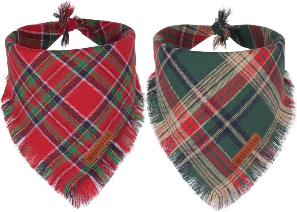 Two plaid bandanas for pets, perfect for the season of giving—one in red and green tartan, the other in green and red, both with frayed edges and a small brown tag.