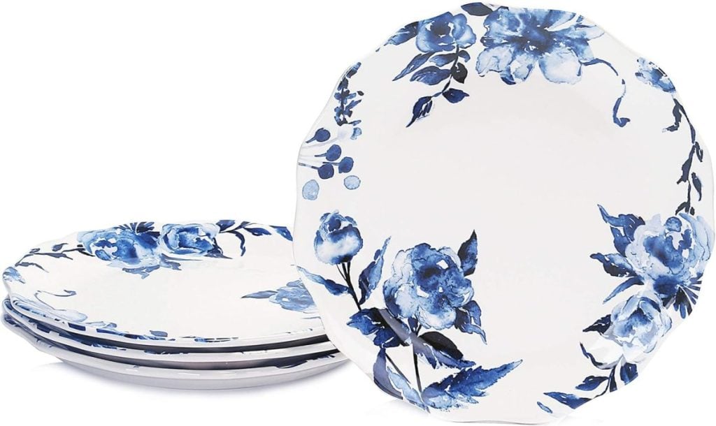 Four white plates with blue floral patterns are stacked, with one plate upright—perfect for showcasing in your blog posts.